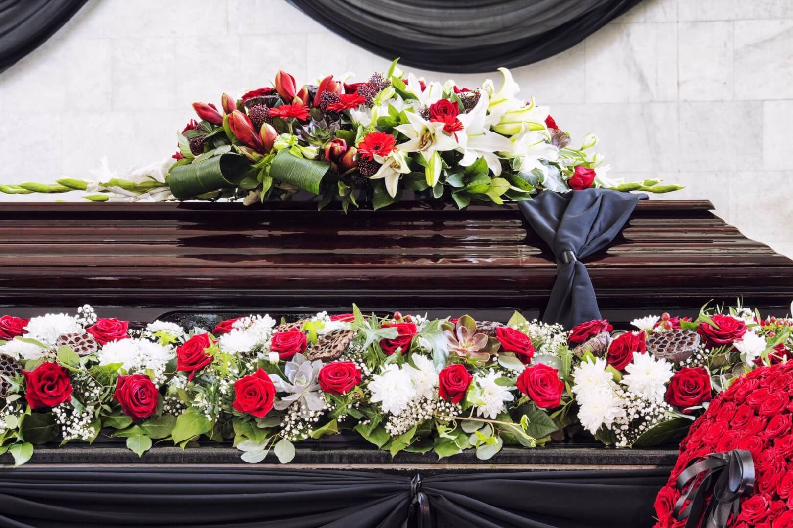 funeral beautifully decorated with flower arrangements coffin close up scaled 1 c6154759